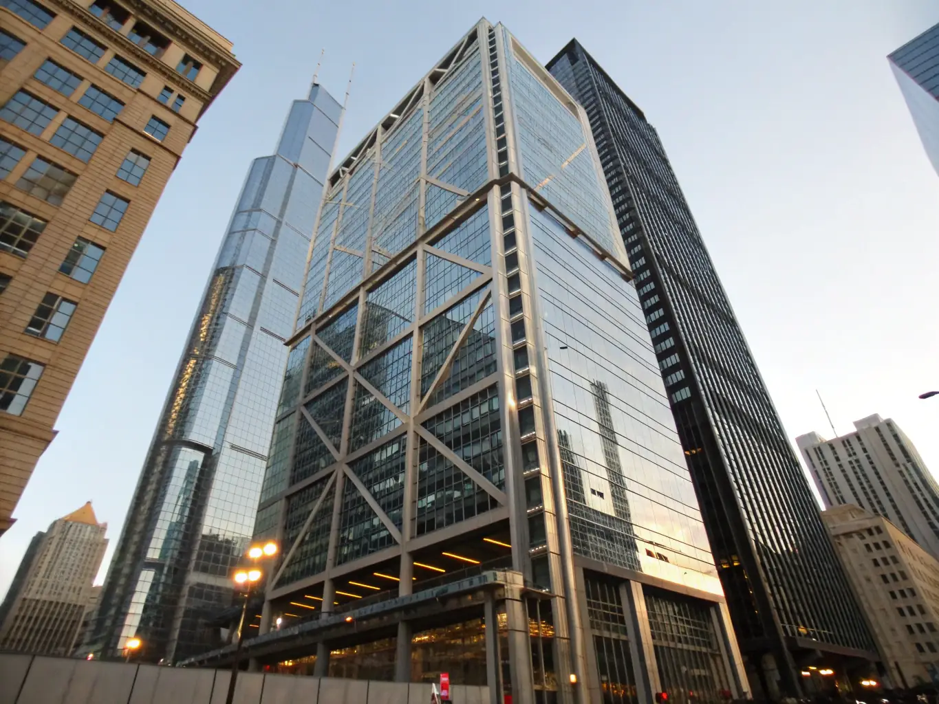 Ultra-realistic image of a modern skyscraper facade, half restored and half weathered, showing a dramatic before-and-after transformation with clean lines and high-end materials, used to illustrate quality restoration results.